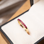 Anel meia aliança em ouro amarelo com 09 rubis naturais de 03 pontos cada. Base 0.3cm aro 16 peso 1.5 gramas.