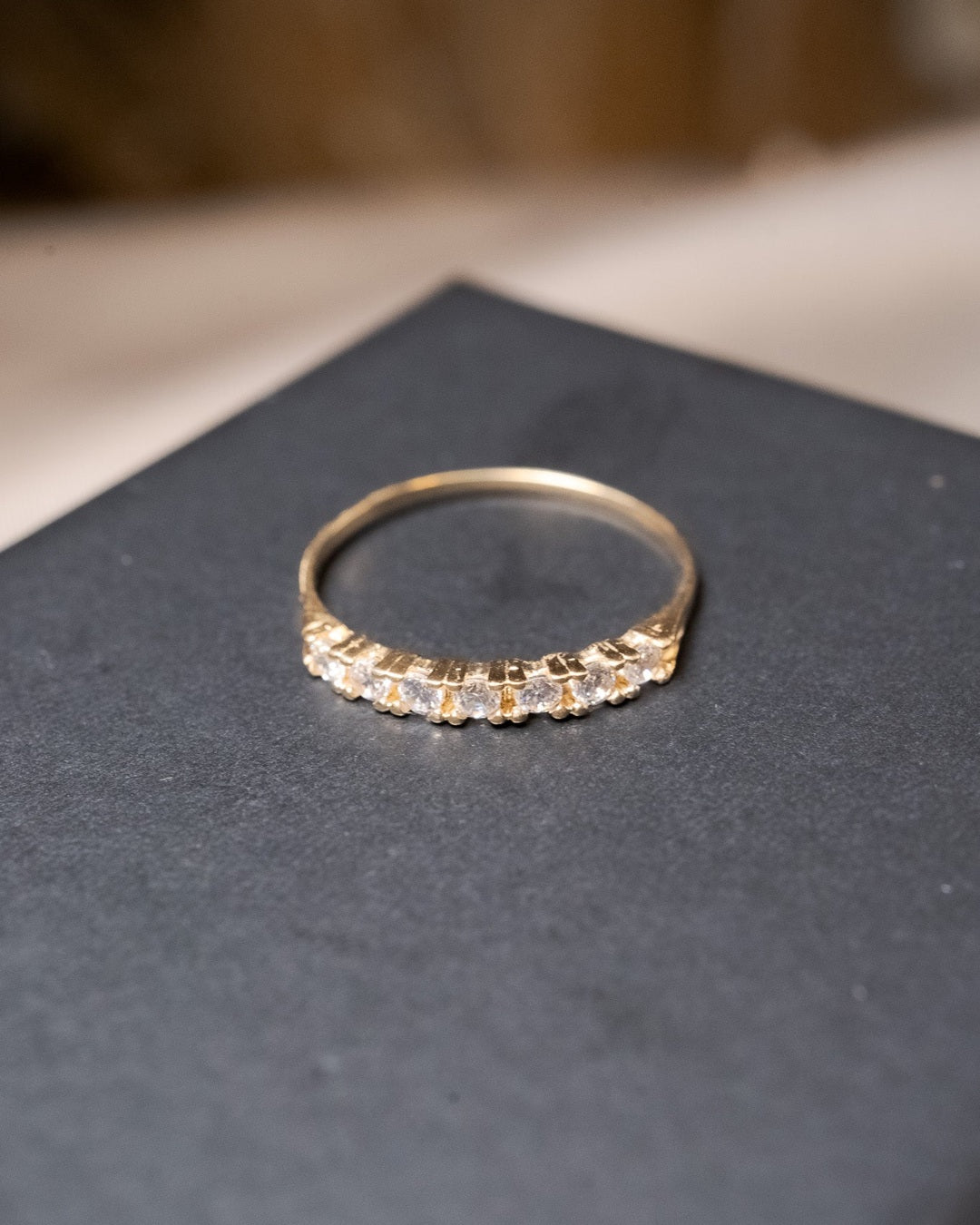 Anel meia aliança em ouro amarelo com 7 safiras brancas naturais de 0.3 pontos cada e base de 0.2cm.