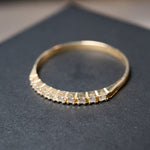 Anel meia aliança em ouro amarelo com 09 diamantes de 0.02 pontos. Peso 0.9g. Aro 18.