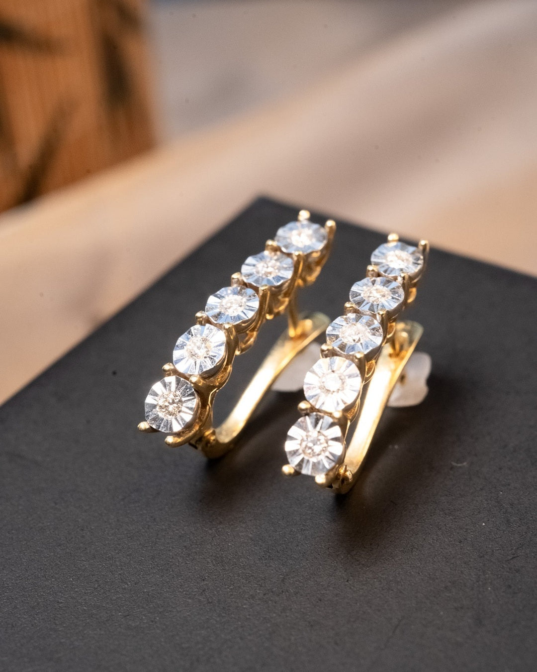 Brincos meia argola em ouro amarelo e branco com 10 diamantes de 0.3 pontos cada. Medem 2.4 x 0.4 cm e pesam 6.2 g.