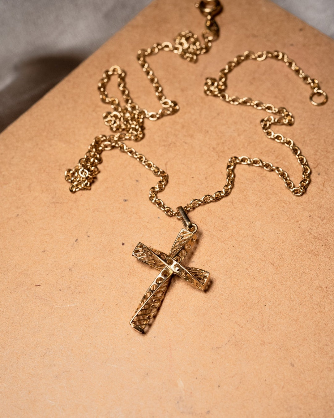 Pingente cruz de ouro amarelo com 3.2x1.7cm e peso de 1.3g.