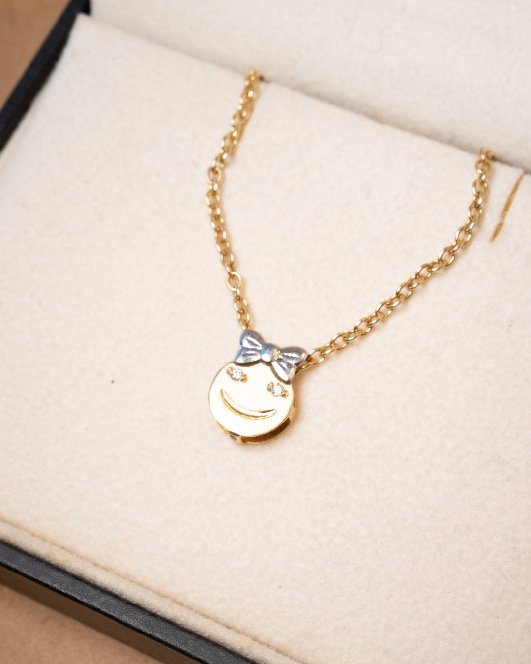 Pingente de menina em ouro amarelo com diamantes. Mede 1.3cm de altura e 1.0cm de largura. Peso de 0.7g.