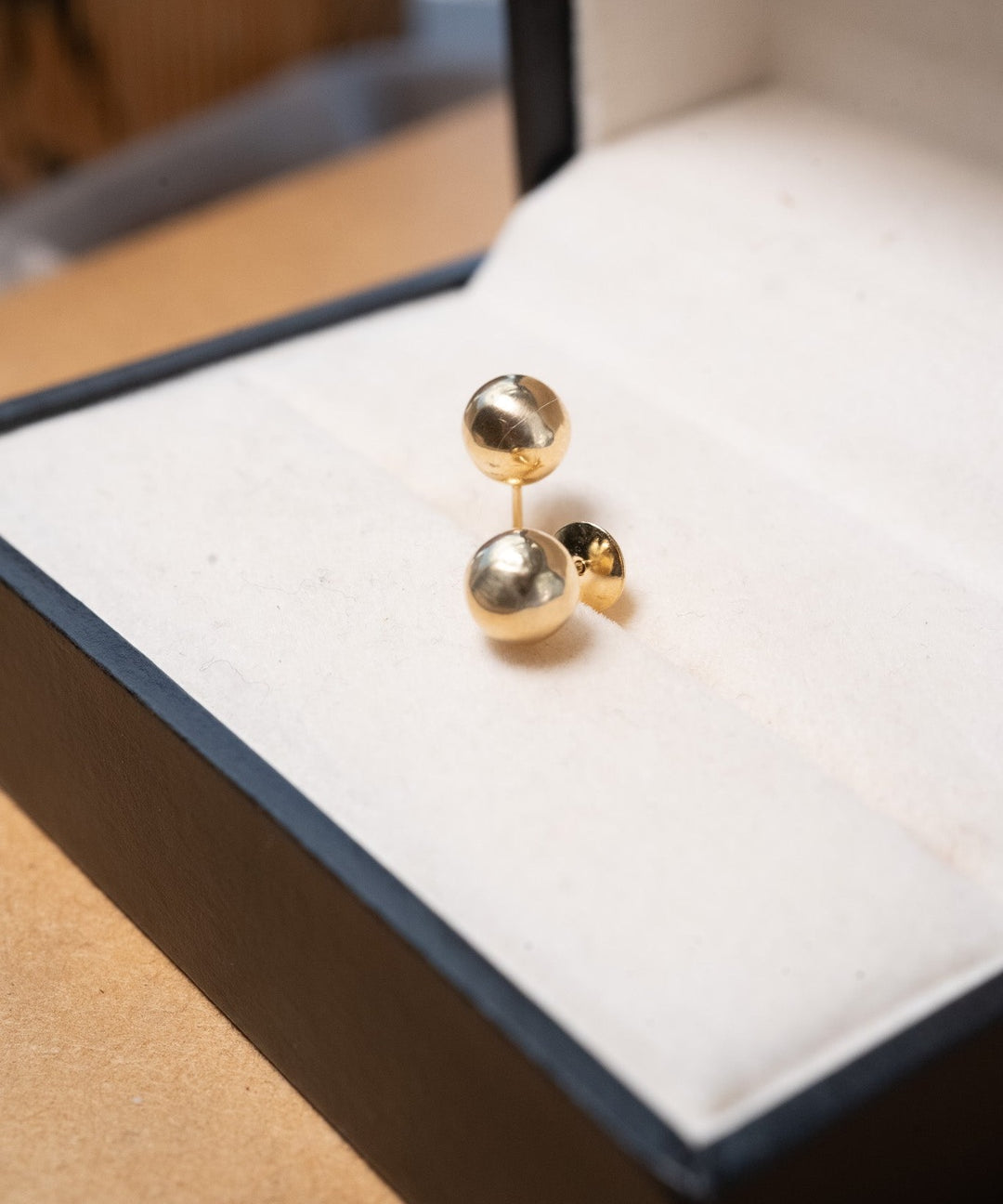 Brinco stud bolinha lisa em ouro amarelo. Peso 0.5g e diâmetro de 0.6cm.
