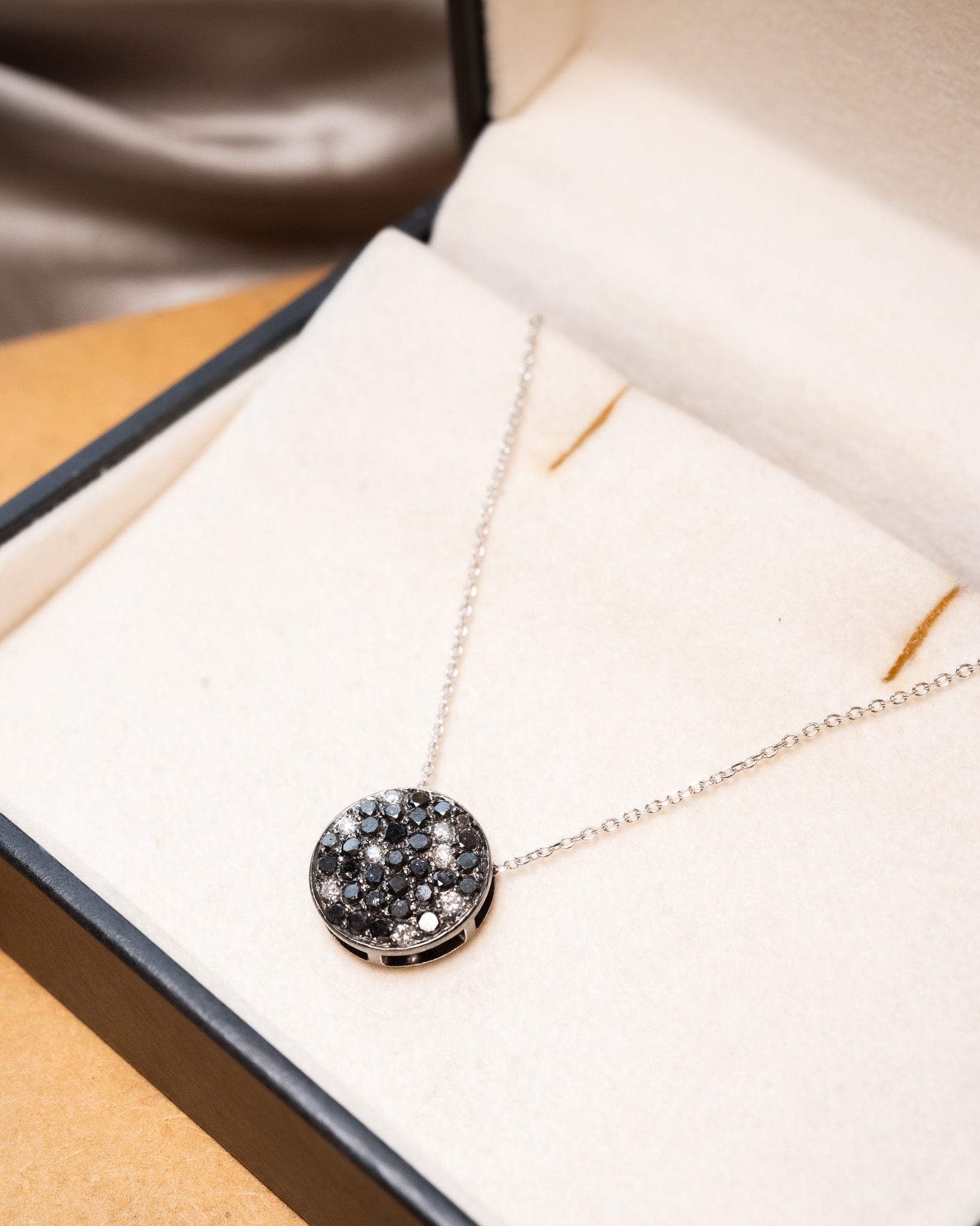 Colar boton em ouro branco com diamantes brancos e negros.