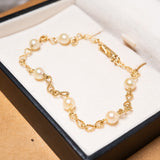 Pulseira infinito em ouro amarelo com pérolas cultivadas de 5mm e 20cm de comprimento e 3.5mm de espessura.
